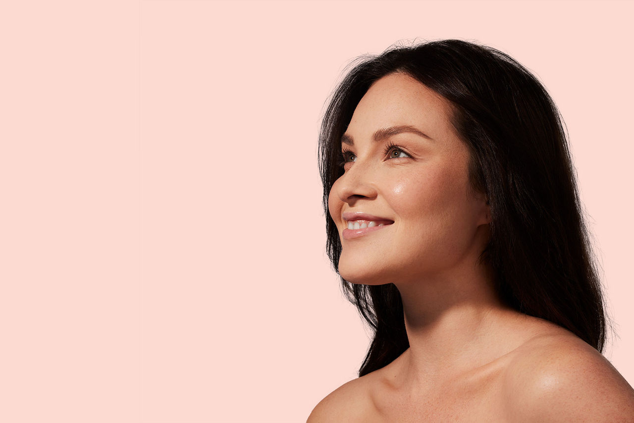 Woman looking out with a pink background