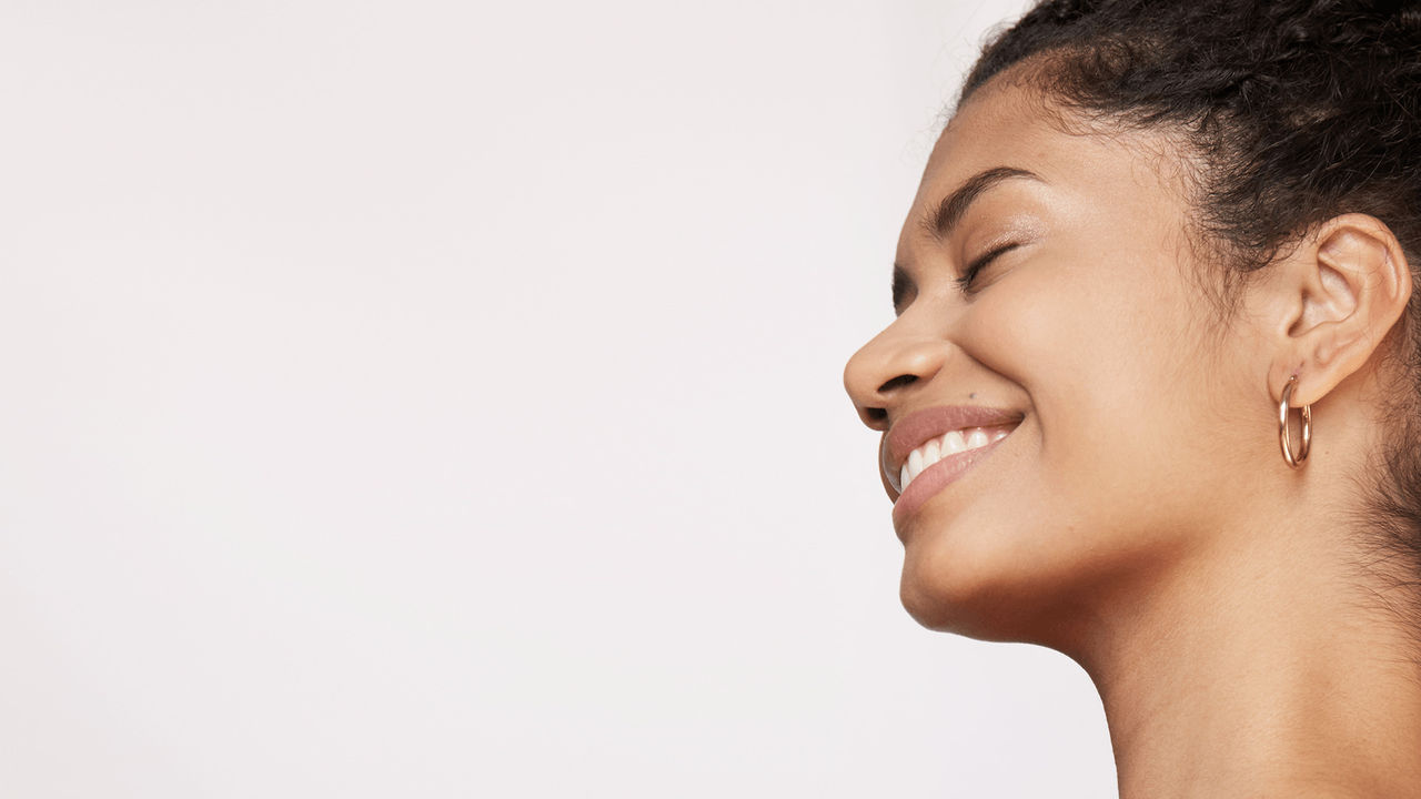 Woman looking to her left with smooth skin